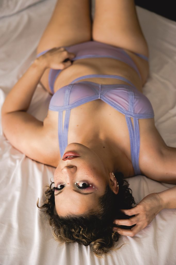 Woman in sheer purple matching lingerie for her Euphoria inspired sexy photo shoot. 