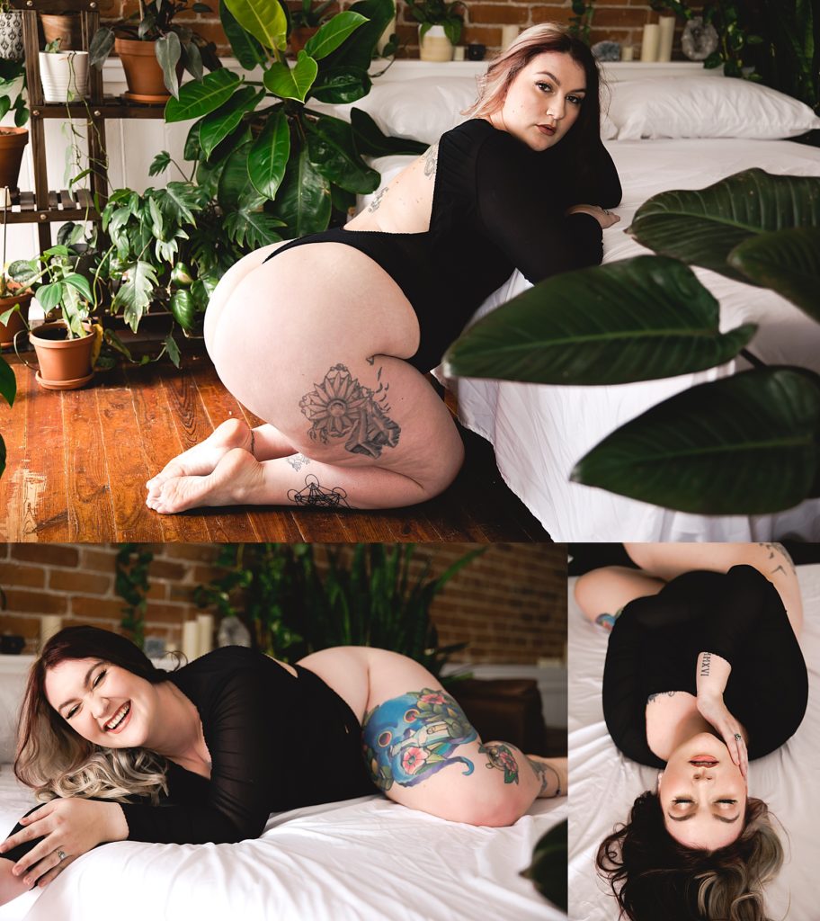 Woman in black lingerie leaning against a bed with plants all around at a boudoir studio in Kansas. 
